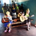 According to information provided by our Kawambwa site, it's a common mindset in the surrounding area that only boys should be permitted to play musical instruments. Our site has broken this barrier to music education by giving both girls and boys the opportunity to play guitar!Many of the children at our Kawambwa site have albinism and are blind or partially sighted, so playing instruments is an activity that everyone can enjoy. The children love to play and sing religious songs during Mass.